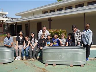 Class standing next to butterfly garden