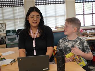 Aide working with student