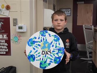 Student showing Earth Day artwork