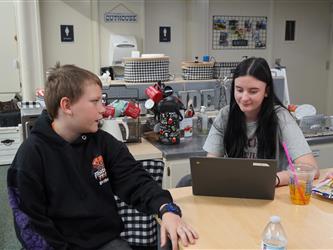 Student working with Aide